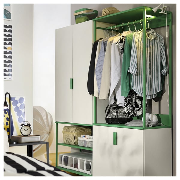 Modern bedroom with green PLATSA storage - open unit, clothes, and shelves.