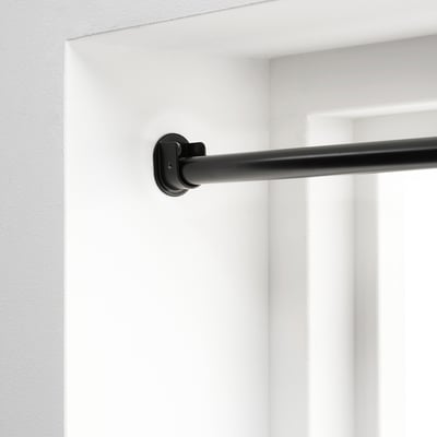 Black RÄCKA curtain rod, extendable, wall-mounted. Offers privacy with full coverage.