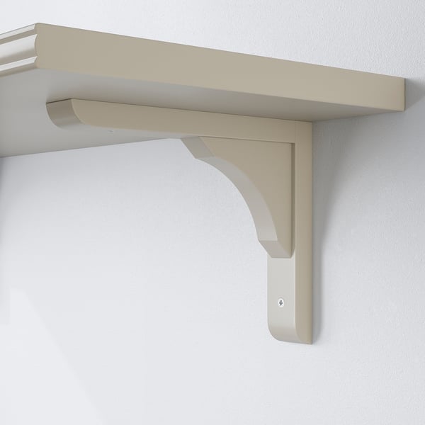 Reversible wall bracket for 20-30 cm shelves. Light beige, sturdy design.