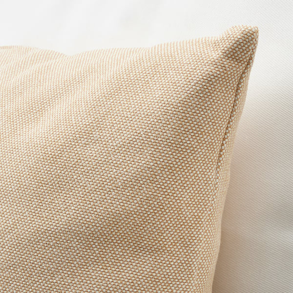 Square throw pillow with a textured, light tan fabric cover. Close-up shows soft, detailed weave and slight sheen, against a neutral beige background.