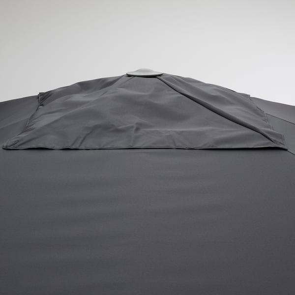 Grey fabric umbrella with sun protection, tilted to block rays.