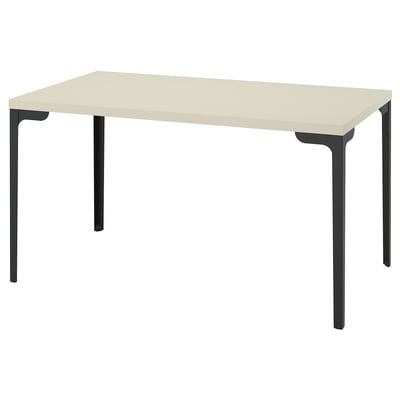The SKÅLSTA table is a beige rectangular desk with black metal legs, featuring a minimalist design.