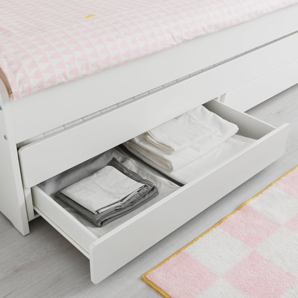 Drawer under bed with folded clothes, showing storage space in SLÄKT.