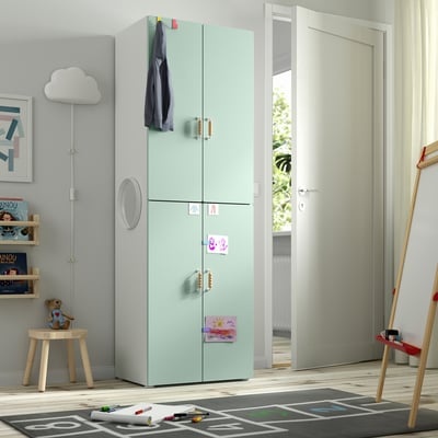 Green SMÅSTAD wardrobe with magnets, coat, toys, emphasising child-friendly design.
