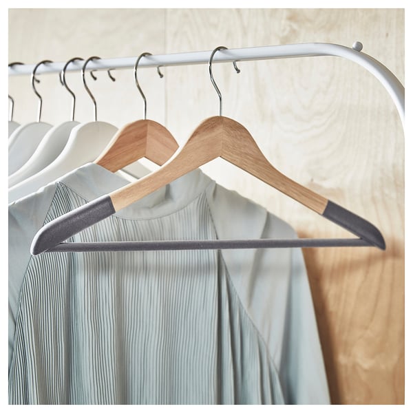 SNYGGING hangers: gray flocked & light brown wooden. Clothes hang neatly on curved steel hook.