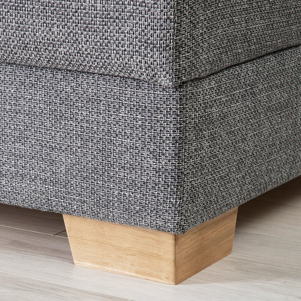 Close-up of a modern sofas corner, showcasing its sturdy fabric and sleek wooden leg.