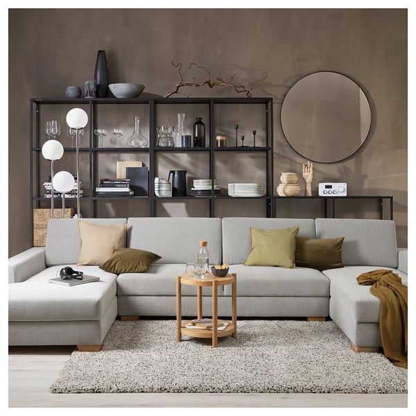 Modern living room with SÖRVALLEN light grey sofa, wooden coffee table, and modular shelves styled with decorative items.