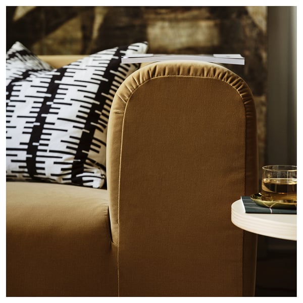 Elegant sofa with brown velvet, plush cushions and black-white throw pillows, inviting relaxation.