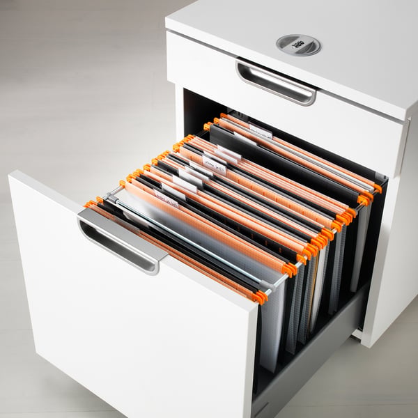 Open white filing cabinet showing orange and grey file folders labelled and holding a4 paper.