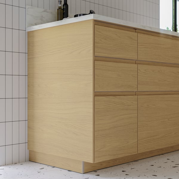 Modern kitchen cabinet with light oak finish, smooth surface, and minimalist design.