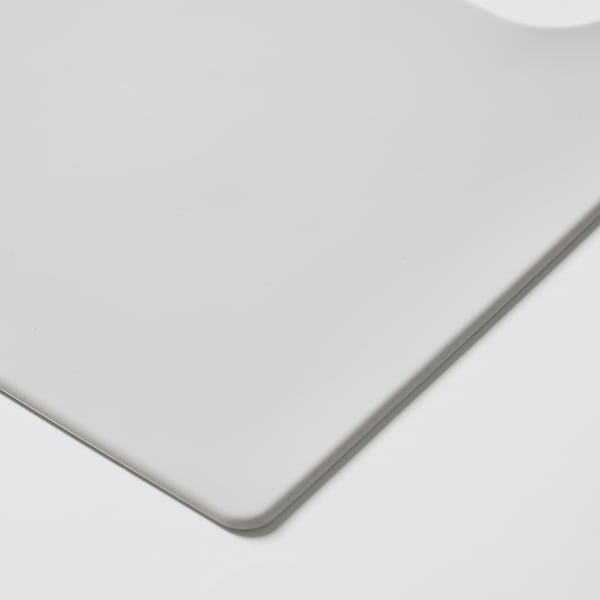Set de table rond, blanc, en silicone. Bord lisse, surface propre.