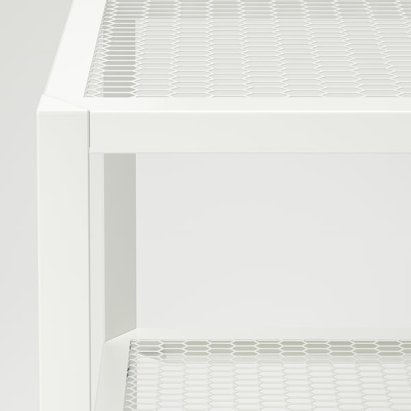 Meuble TV blanc moderne avec étagères à motifs hexagonaux. Lignes épurées, construction robuste et design minimaliste.