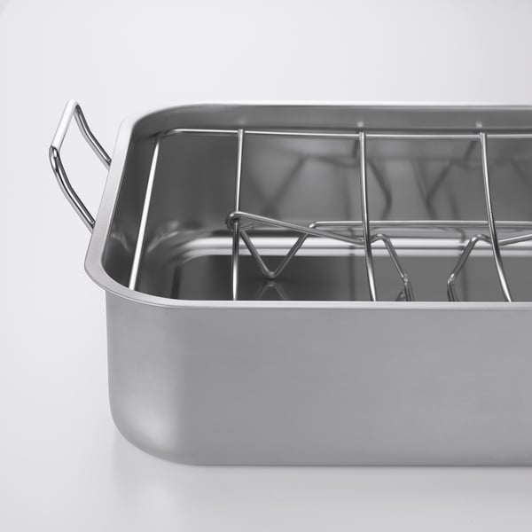 Plat à rôtir en acier inoxydable avec grille en forme de U, deux poignées solides, conçu pour un usage au four ou au barbecue.
