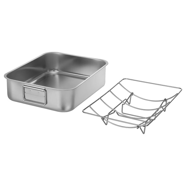 Plat à rôtir en acier inoxydable avec anses, incluant une grille métallique pour la cuisson en hauteur. Un design moderne et fonctionnel.
