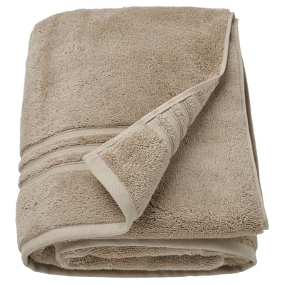 Serviettes en coton biologique BROKGLIM, beige, piles de tissu éponge texturé plié avec bordure tissée.