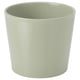 Jardinière en céramique rayée vert clair avec une forme lisse et arrondie.