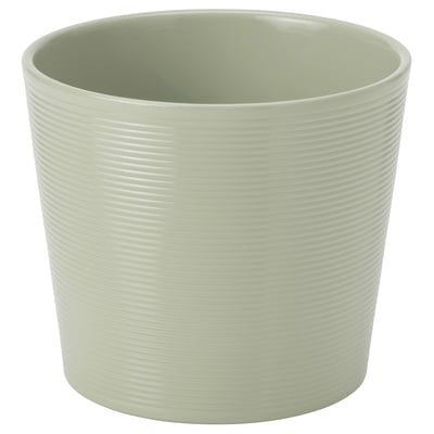 Jardinière en céramique rayée vert clair avec une forme lisse et arrondie.