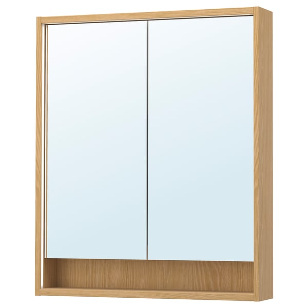 Une armoire de toilette en bois FAXÄLVEN avec éclairage intégré. Il est rectangulaire, brun clair, avec un design élégant et une étagère au fond.