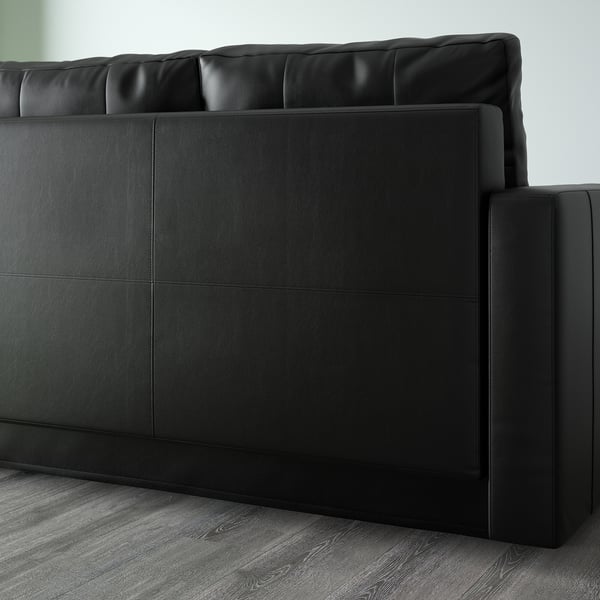Canapé convertible noir avec rangement intégré et dossier rembourré, idéal pour les espaces à usages multiples.