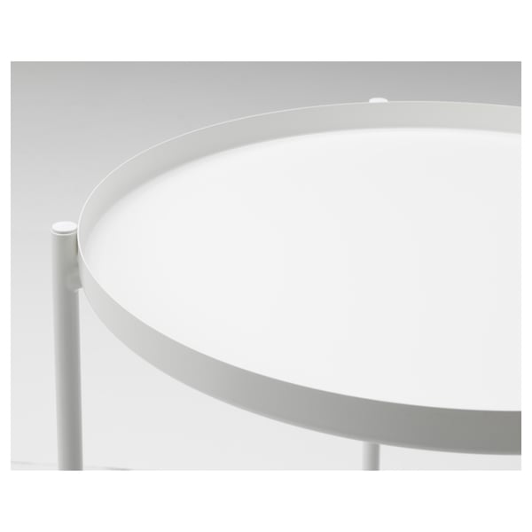 Table ronde en métal avec bord incurvé, plateau et supports blancs. Moderne, durable et facile à nettoyer.