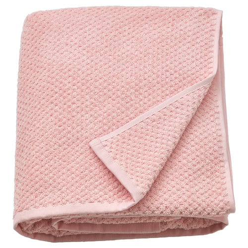 Serviette GULVIAL douce et rose clair, pliée, 100 % coton, moyennement épaisse, texturée.