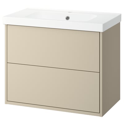 Une meuble de salle de bain murale beige avec deux tiroirs et un lavabo en céramique blanche. Le design est minimaliste et pratique avec une finition lisse.