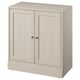 Une armoire HAVSTA beige en pin massif avec une finition brossée, présentant un design simple et rectangulaire avec deux portes à fermeture douce.