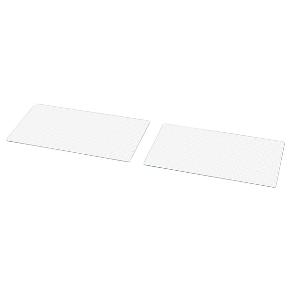 Deux plaques de verre transparentes, rectangulaires, avec un motif de grille, sont posées à plat côte à côte.