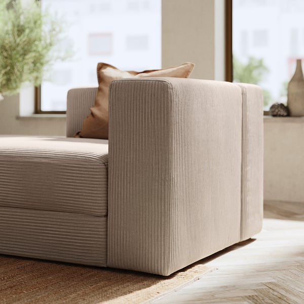 Canapé beige moderne avec texture nervurée, design minimaliste.