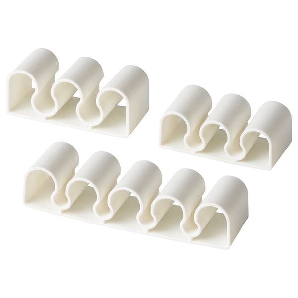 Quatre organisateurs de câbles en plastique blanc KALKSTUFF, chacun avec plusieurs fentes, disposés soigneusement dans un motif carré.