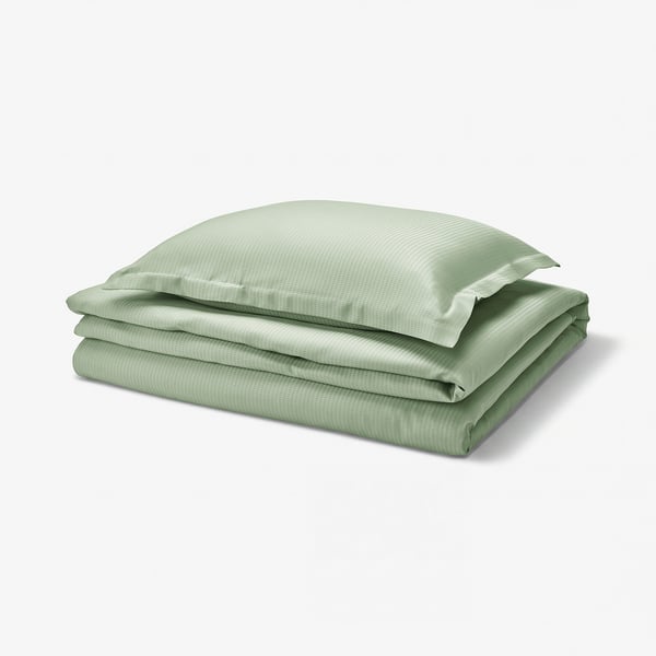 Ensemble de literie vert LÄKEVÄNDEROT. Couette et oreiller pliés avec tissu lisocell lisse et soyeux.