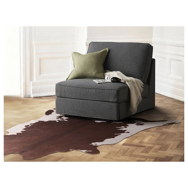 Tapis polyvalent MAXTAXA , imprimé en vache, brun foncé sur crème, polyester recyclé, en forme de L, suspendu au mur.
