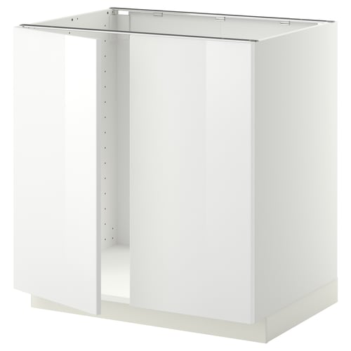 Présente une base d’armoire de cuisine METOD blanche, de forme carrée, avec une finition lisse et brillante, conçue pour les appareils encastrés.