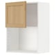 Armoire ouverte en placage de chêne de la série ikea METOD. Intérieur blanc, porte en bois clair, à charnière droite.
