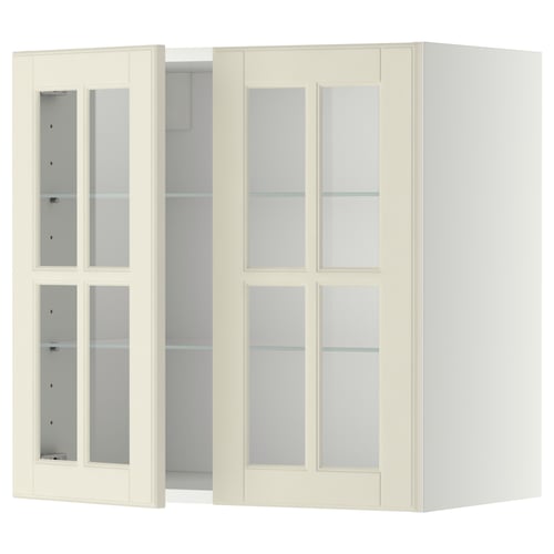 Une armoire murale METOD de couleur crème avec des portes en verre. Il a une forme rectangulaire et un design traditionnel, avec des étagères réglables.