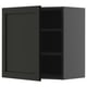 Armoire murale vert foncé avec porte simple et deux étagères.