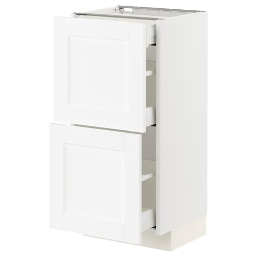 L’armoire de cuisine ikea METOD blanche au design moderne, avec deux portes et deux tiroirs visibles, encadrée de plastique imitation bois.
