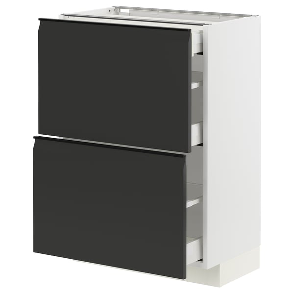 Un meuble de cuisine METOD blanc moderne avec deux tiroirs noirs mats avec poignées intégrées et bords inclinés, sur fond blanc.