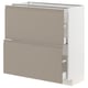 Une armoire de cuisine moderne du système ikeas METOD de couleur gris-beige mat avec des poignées intégrées et un design élégant et chanfreiné.