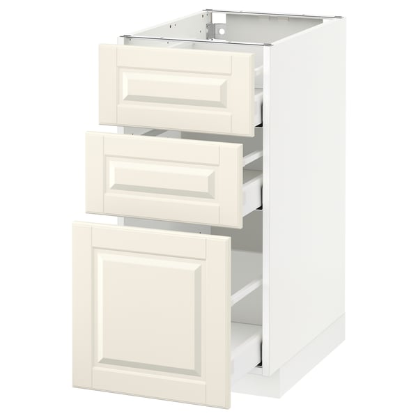 Un meuble de cuisine METOD blanc cassé avec trois tiroirs coulissants et une porte, encadré par des bords biseautés.