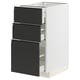 Armoire de cuisine METOD blanche moderne avec trois tiroirs noirs, des poignées élégantes et des lignes épurées.