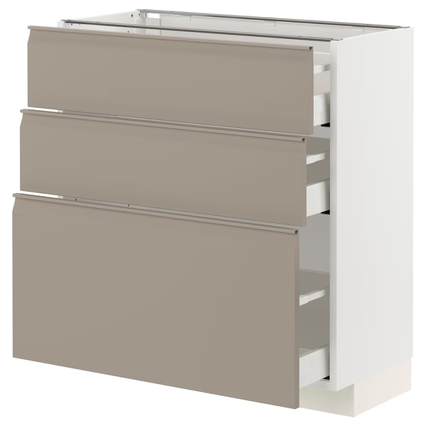 Armoire de cuisine moderne avec trois tiroirs lisses et beiges avec poignées intégrées, sur un fond blanc.