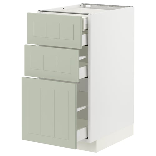 Unité de cuisine moderne avec trois tiroirs verts et armoire blanche.