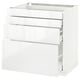 Armoire de cuisine blanche et brillante avec trois tiroirs et dessus ouvert.