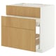 Armoire en bois blanc avec trois tiroirs.