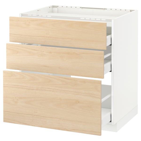 Armoire de cuisine blanche moderne avec trois tiroirs en bois clair, partiellement ouverts, mettant en valeur des glissières lisses et un intérieur organisé.