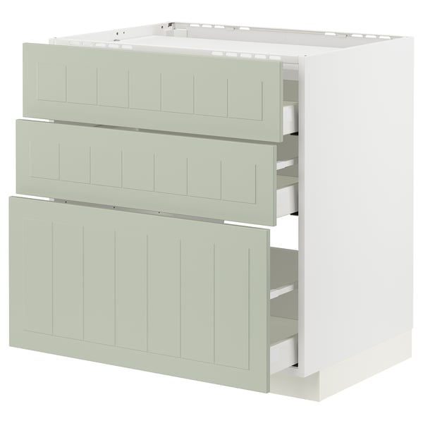 Armoire de cuisine blanche avec trois tiroirs verts et rainures verticales.