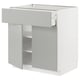 Une armoire de cuisine METOD blanche avec un tiroir et deux étagères. Le design épuré et moderne des poignées gris clair.