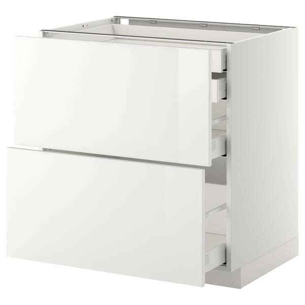 Une armoire de cuisine moderne entièrement blanche du système METOD avec une finition brillante et des tiroirs à fermeture automatique.