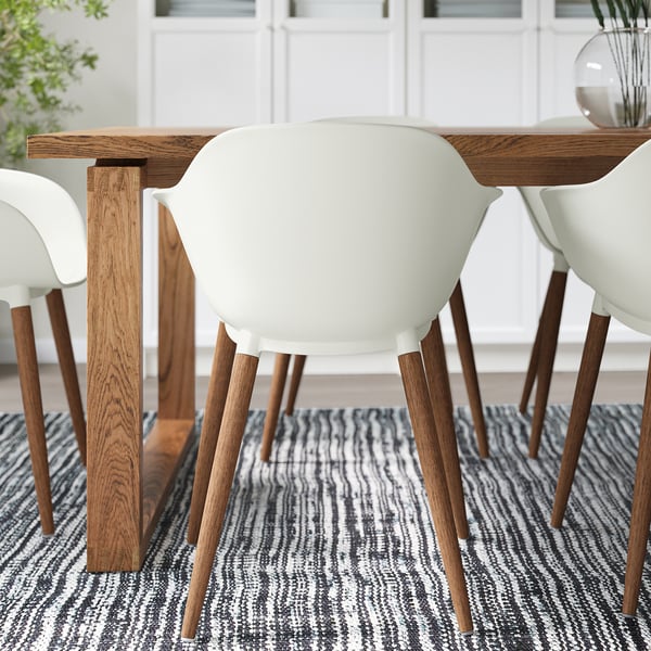 Table à manger en bois avec chaises blanches ; Grain de bois naturel, assise confortable.